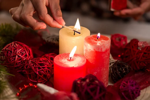 Childs hand lighting Christmas candles. — Stock Photo, Image