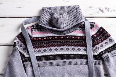 Womans pullover with small ornament.