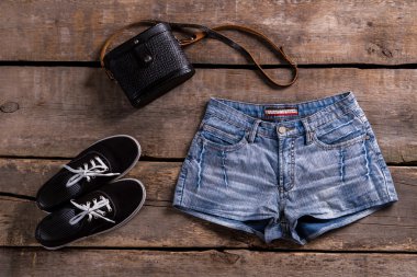 Womans denim shorts with handbag.