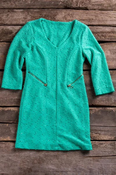 Turquoise dress with zipper pockets.