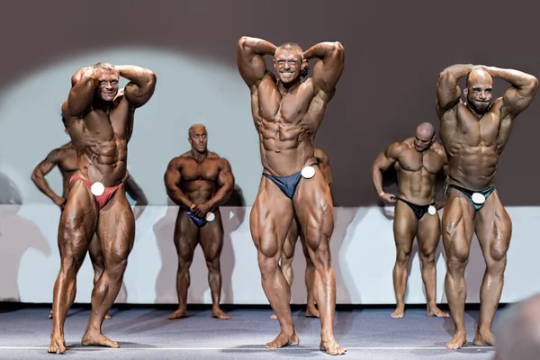 Bodybuilders showing muscles. — Stock Photo, Image