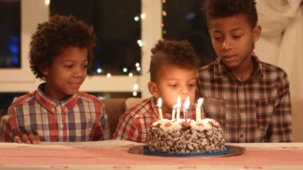 Niños soplando velas de pasteles . — Vídeo de stock