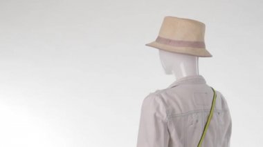 Female mannequin in jacket turning.