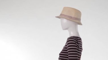 Mannequin in striped top turning.