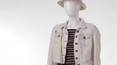 Female mannequin wearing denim jacket.