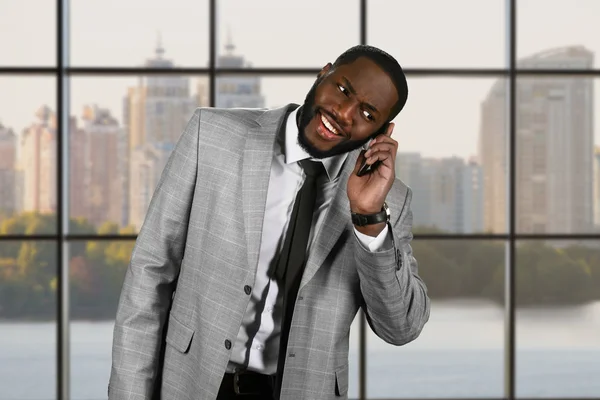 Surprised afro man holding phone. — Stock Photo, Image