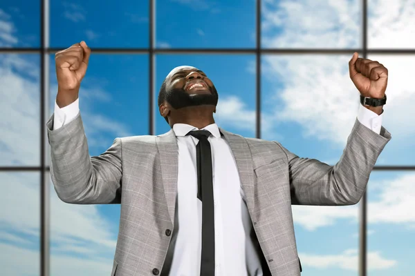 Cheerful afro businessman in jacket. — Stock Photo, Image