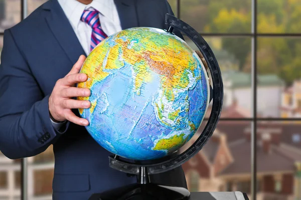 Businessman touching globe with hand. — Stock Photo, Image