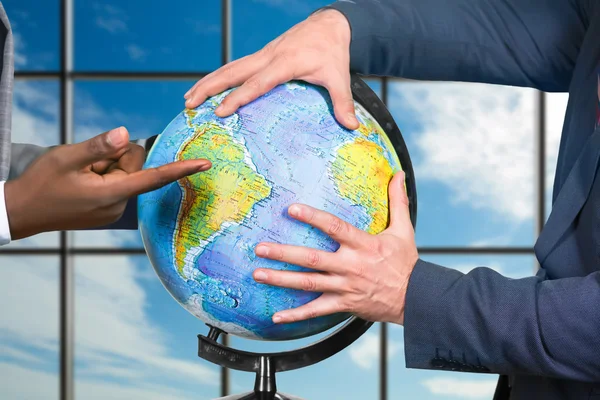 Businessmens hands touching globe. — Stock Photo, Image