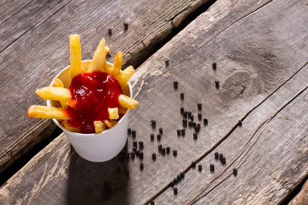 Fritas com ketchup e pimenta . — Fotografia de Stock