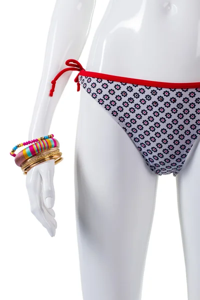 Colorful bracelets and swimsuit bottom. — Stock Photo, Image