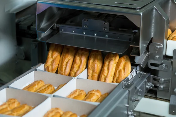 Cajas con pastelería en cinta transportadora . —  Fotos de Stock