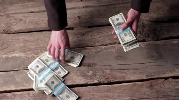 Male hands taking dollar bundles. — Stock video