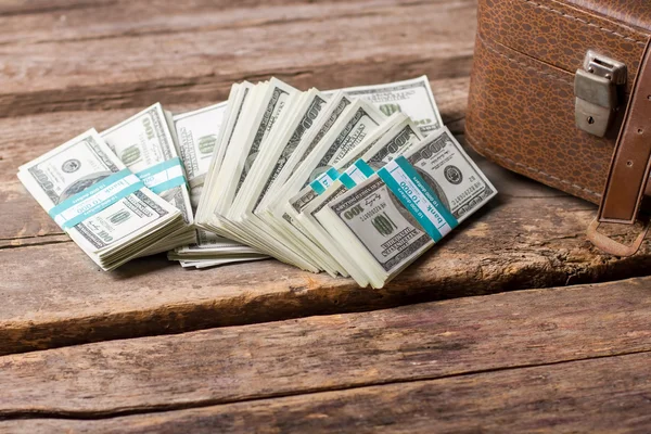Dollar bundles and brown case. — Stock Photo, Image