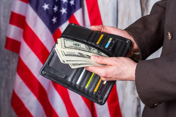 Businessman holding wallet with dollars. — Stock Photo, Image