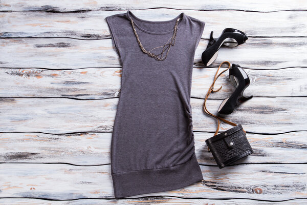 Gray sleeveless top and heels.