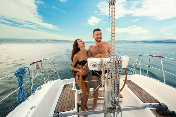 Smiling people at yacht wheel. — Stock Photo, Image