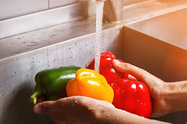 Male hands wash yellow paprika. — Stock Photo, Image