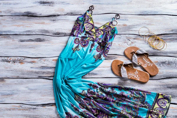 Long blue dress and bracelets.