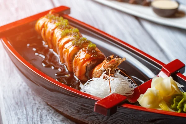 Cooked shrimp on sushi boat.