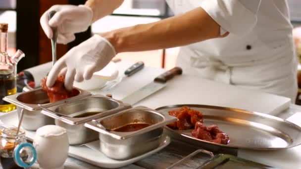 Hands taking meat from liquid. — Stock Video