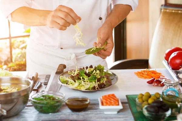 Mãos masculinas fazem salada . — Fotografia de Stock