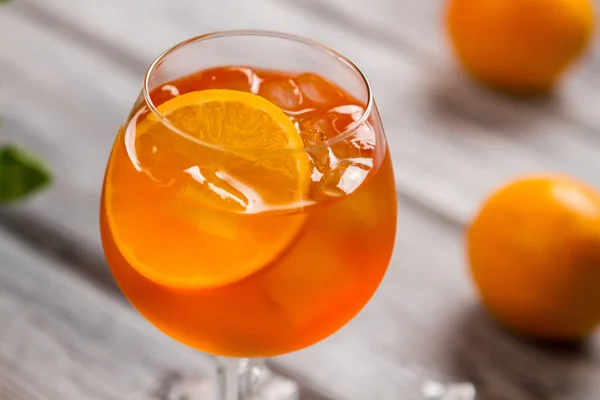 Orange drink in a wineglass.