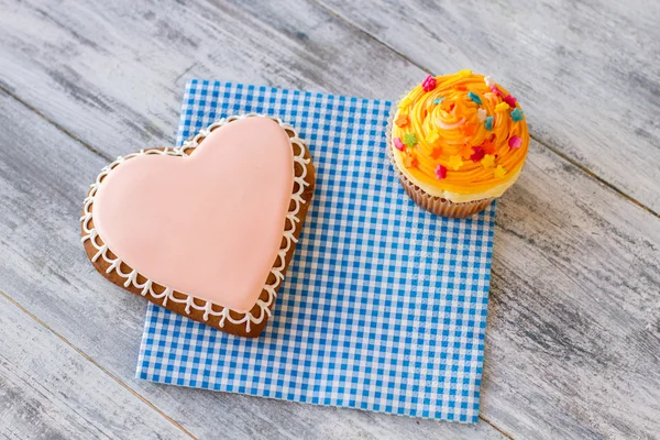 Cupcake cookie i pomarańczowy serce. — Zdjęcie stockowe