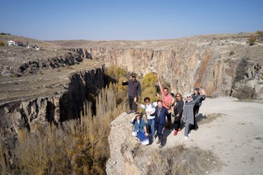 Ihlara vadisinin arka planında bir grup turist.