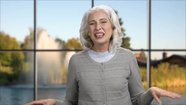 Cheerful mature woman can not stop laughing. — Stock Footage Cheerful mature woman can not stop laughing. Video Clip