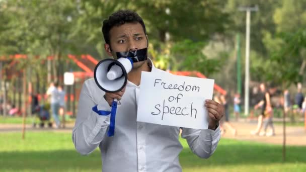 Censored male activist potesting with megaphone. — Stock Video