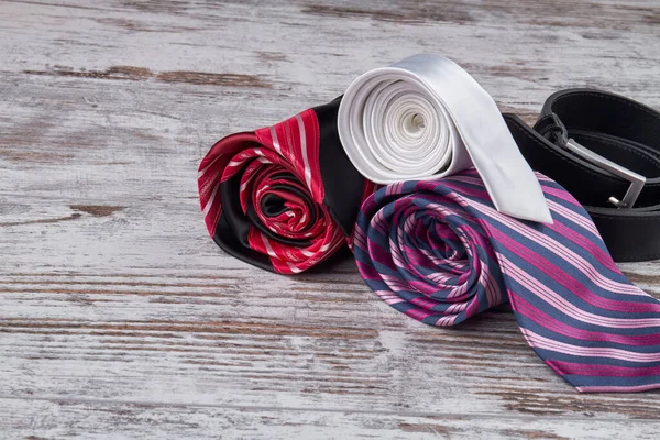 Rolled silk ties and belt. — Stock Photo, Image