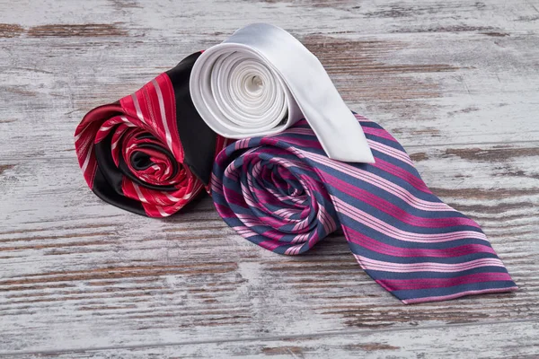 Colored silk ties on a white table. — Stock Photo, Image