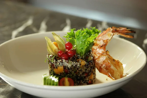 Quinoa salad served with vegetables.