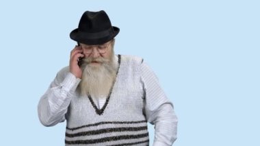 Cep telefonuyla konuşan yaşlı bir adam.