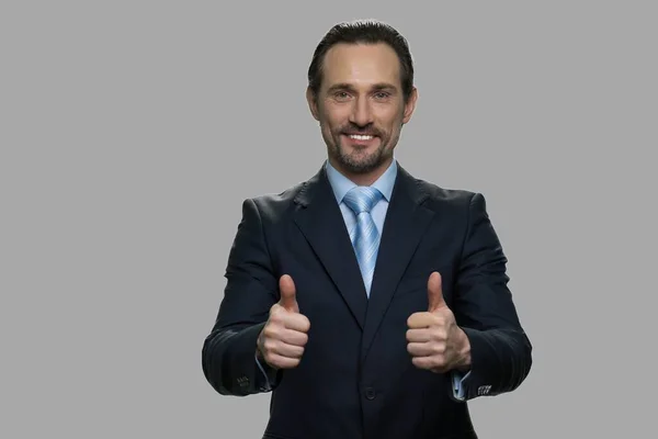 Handsome businessman showing two thumbs up. — Stock Photo, Image