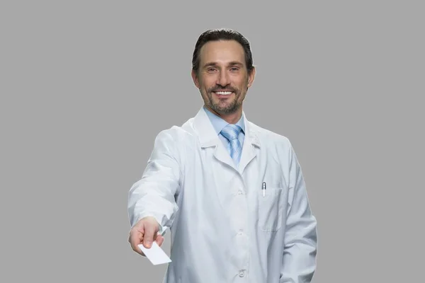 Successful male doctor offering business card. — Stock Photo, Image