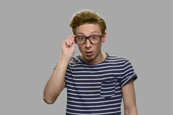 Nerd boy in eyeglasses with surprised facial expression. — Stock Photo, Image