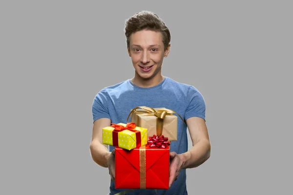 Retrato de adolescente oferecendo caixas de presente. — Fotografia de Stock
