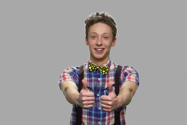 Successful teen boy giving thumbs up to camera. — Stock Photo, Image