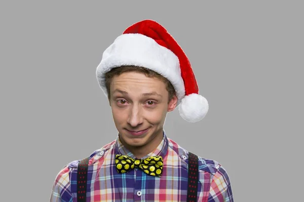 Funny teen boy in Christmas hat. — Stock Photo, Image