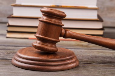 Yargıç tokmağı ve hukuk kitapları arkada duruyor..
