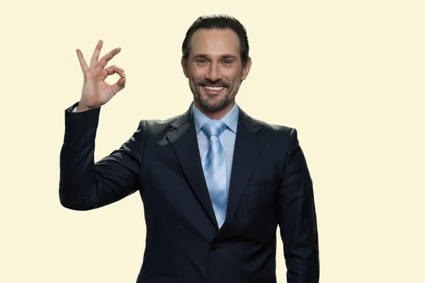 Cheerful middle-aged businessman showing ok gesture. — Stock Photo, Image