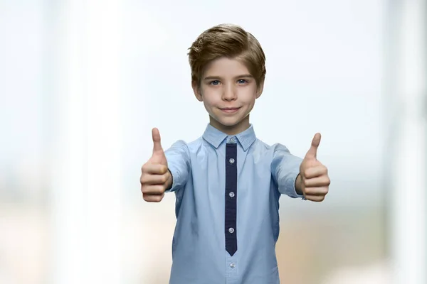 Handsome first grader is showing like gesture. — Stock Photo, Image