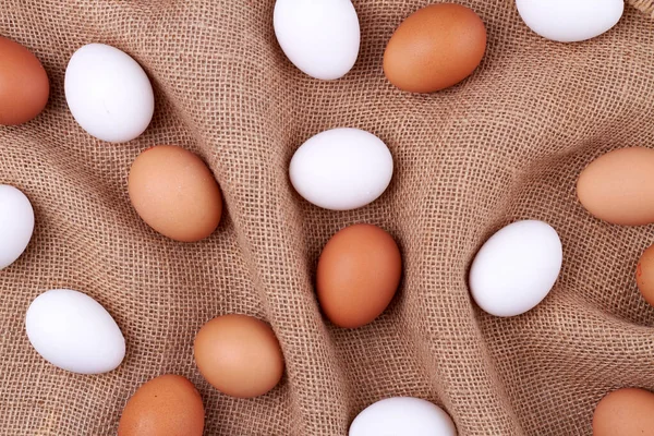 Ovanifrån bruna och vita ägg på jute tyg. — Stockfoto
