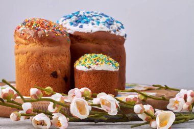 Paskalya pastaları beyaz arka planda beyaz laleler ve kremalı..