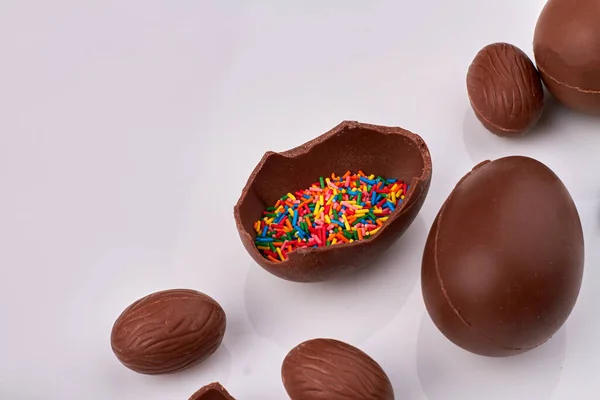 Close-up chocolate eggs filled rainbow sprinkles.