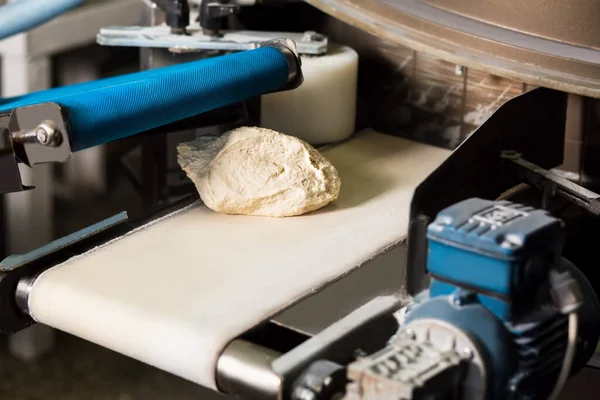 Raw bread dough at conveyor belt. Food production. —  Fotos de Stock