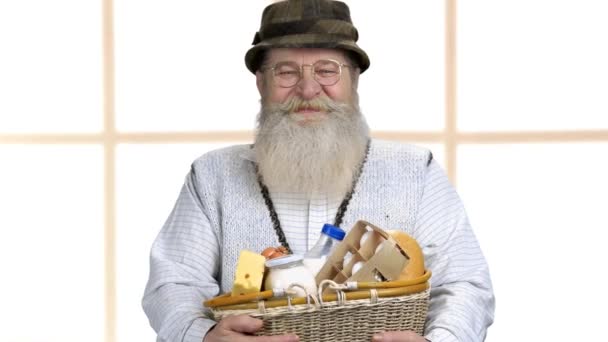 Smiling farmer holding basket with milk products. — Stock videók