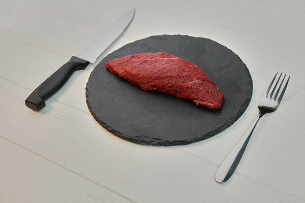 Raw uncooked fillet steak on a plate.